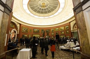 Members of the community gather to listen to kirtan