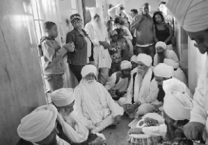Keertan (hymn singing) for Nelson Mandela’s health and wellbeing in the corridor outside his former prison cell (Robben Island off Cape Town Coast). Onlookers were heartened to see people of the Sikh Dharam praying for the good health of ‘Madiba’. Dec 2012 
