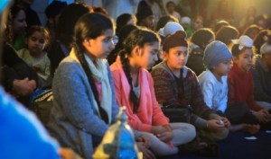 Attendees attentively listen as the concert begins.