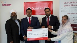 Ravinder Singh Sidhu and Harry Singh Saggu (both centre) present cheque to Amrick Singh and Narinder Kaur (L & R)