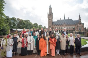 Interfaith leaders standing together in front of the International Peace Palace, The Hague