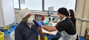 Amrick Singh receives vaccination 
from Aghia Pal Singh
